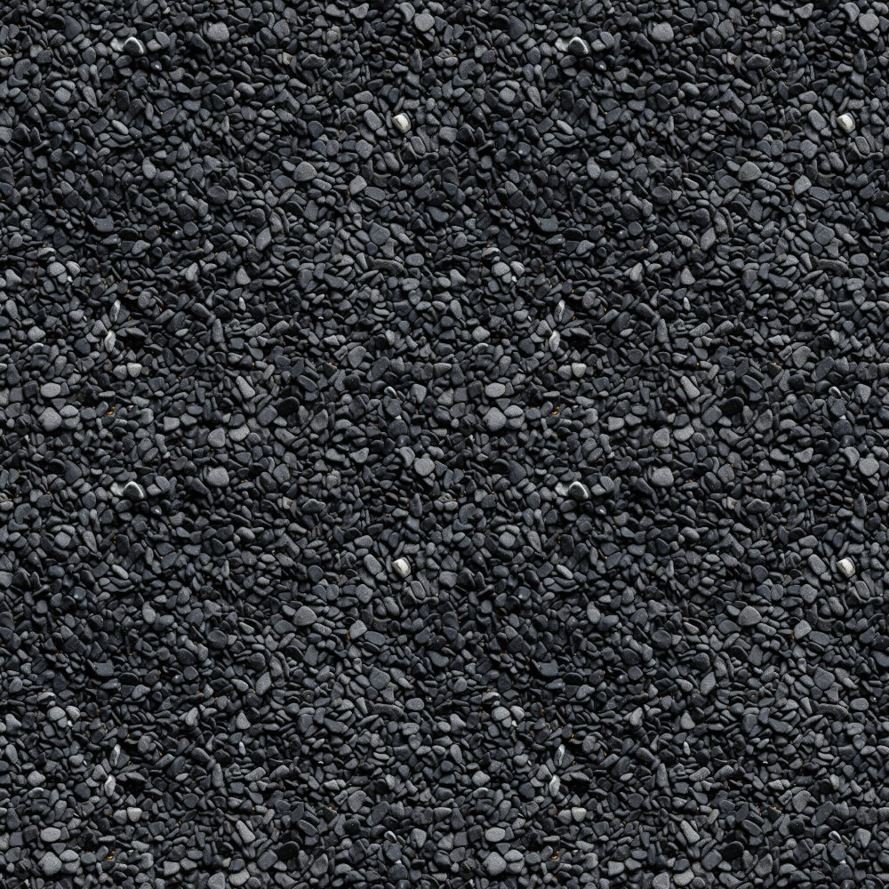 A textured surface of small, uniform dark gray stones closely packed together.