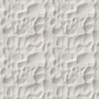 Close-up of white sand with rippled patterns and shadows.
