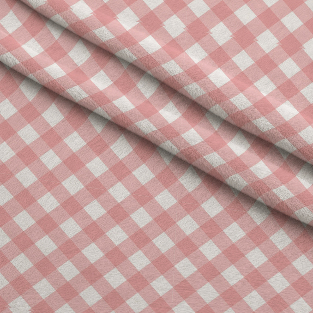 Diagonal Gingham Peach Puff Fleece Fabric — fleece fabric folded close-up preview (mv-fleece-v1:lying)