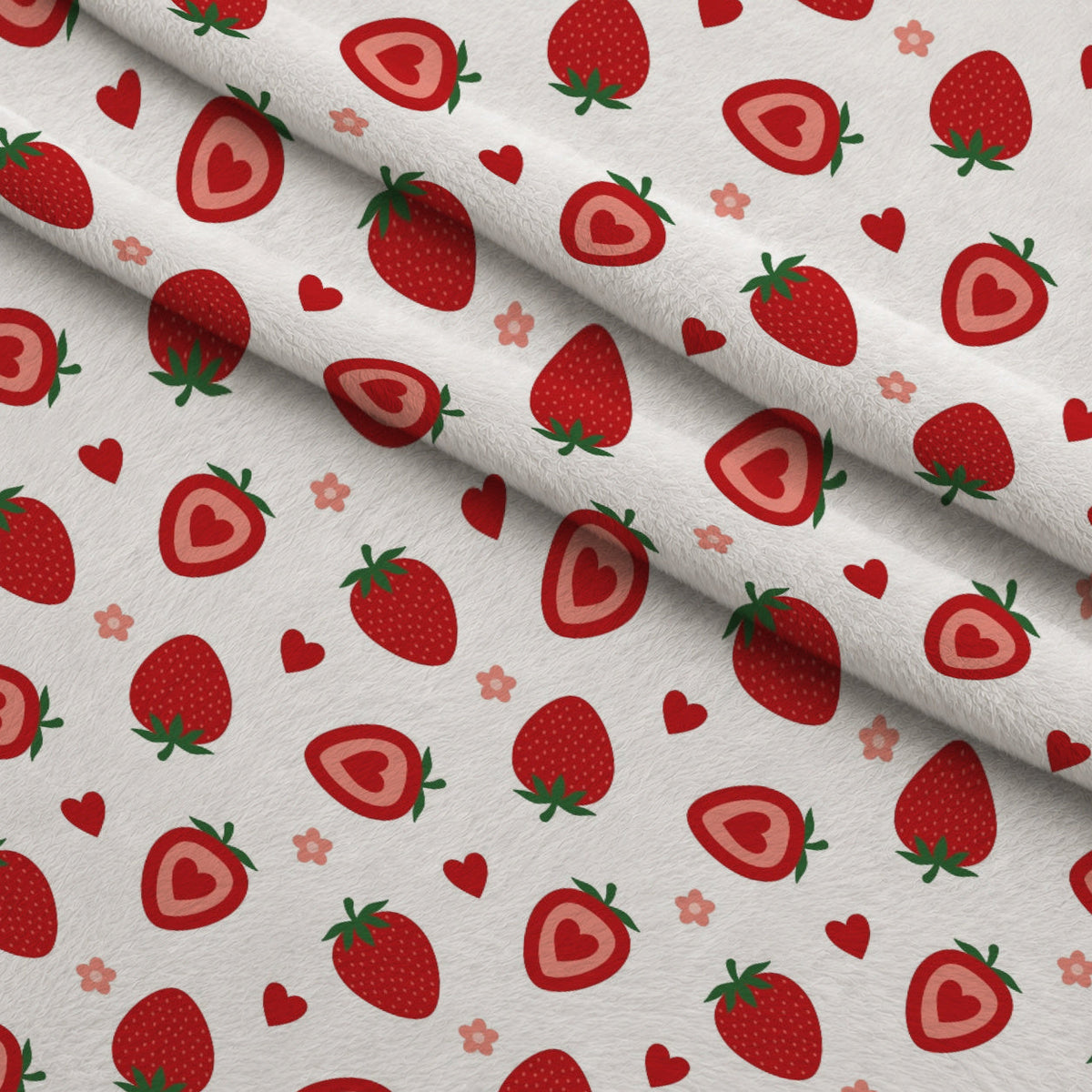 Sweet Strawberries Flowers and Hearts Fleece Fabric — fleece fabric folded close-up preview (mv-fleece-v1:lying)
