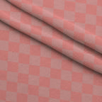 Two Tone Checkered Peach Puff Fleece Fabric — fleece fabric folded close-up preview (mv-fleece-v1:lying)